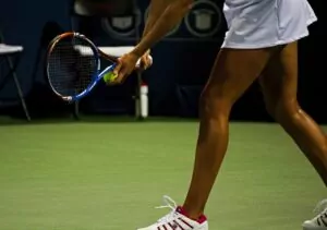 tennis player experiencing wrist pain, potential symptoms of a sprained wrist