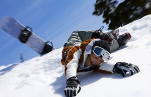 Fallen person that is experiencing a common ski & snowboarding injury